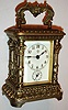 Ansonia Clock Co., Brooklyn, N.Y., "Astral" model carriage clock, ornate cast case with old lacquer finish, 30 hour time and alarm movement, white enamel Arabic numeral dial with blued steel hands, under a thick beveled glass, with key c1905