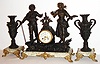 France, three piece mantel garniture, 8 day, time and strike, pendule a Paris movement, the clock case with a harvest theme, male and female figures with rake and scythe, clock case decorated with flower garlands, white enamel Roman numeral dial with a polychrome enamel center featuring a bird holding floral garlands supporting a nest with eggs above the 6, gilt Louis XV style hands, gilt bezel with convex beveled glass, all on a white marble base with blue green veining, supported by scrolled feet, the urn form candle holders with handles and floral ornament, set on bases matching the clock, c1880
