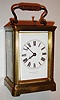 France, for Montgomery Bros., Los Angeles, 8 day petit sonnerie carriage clock with repeating on gongs, two train time and strike movement with lever platform, white enamel Roman numeral dial, blued steel hands, Corniche style case with beveled glasses, with outer leather covered travelling case and key, c1910