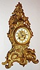 France, gilt cast brass mantel clock in the rococo style, the case decorated with acanthus, C scrolls and flower garlands, white enamel Arabic numeral dial with gilt ornamental cast center, blued steel hands, gilt bezel with thick beveled glass, 8 day, time and strike, pendule a Paris movement signed "Japy Freres", c1910