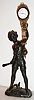 Junghans, Germany, "Bat Boy" novelty swinger, patinated spelter figure of a boy with bat and ball supporting the gilt and patinated swinging eight day clock/ pendulum, white enamel Arabic numeral dial with Junghans logo, blued steel hands c1920