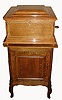 Regina Music Box Co., Rahway and Jersey City, N.J., Style No.11, table top 15 Ohm inch, double comb, disc playing music box, quarter sawn oak case with mother of pearl dot and white line inlays, stepped molded top, and molded base supported on turned ball feet, inside of lid with orig label from C. J. Heppe and Son, Philadelphia, and Regina label, together with a quarter sawn oak disc storage cabinet with 15+ discs, bedplate serial #55312, c1900