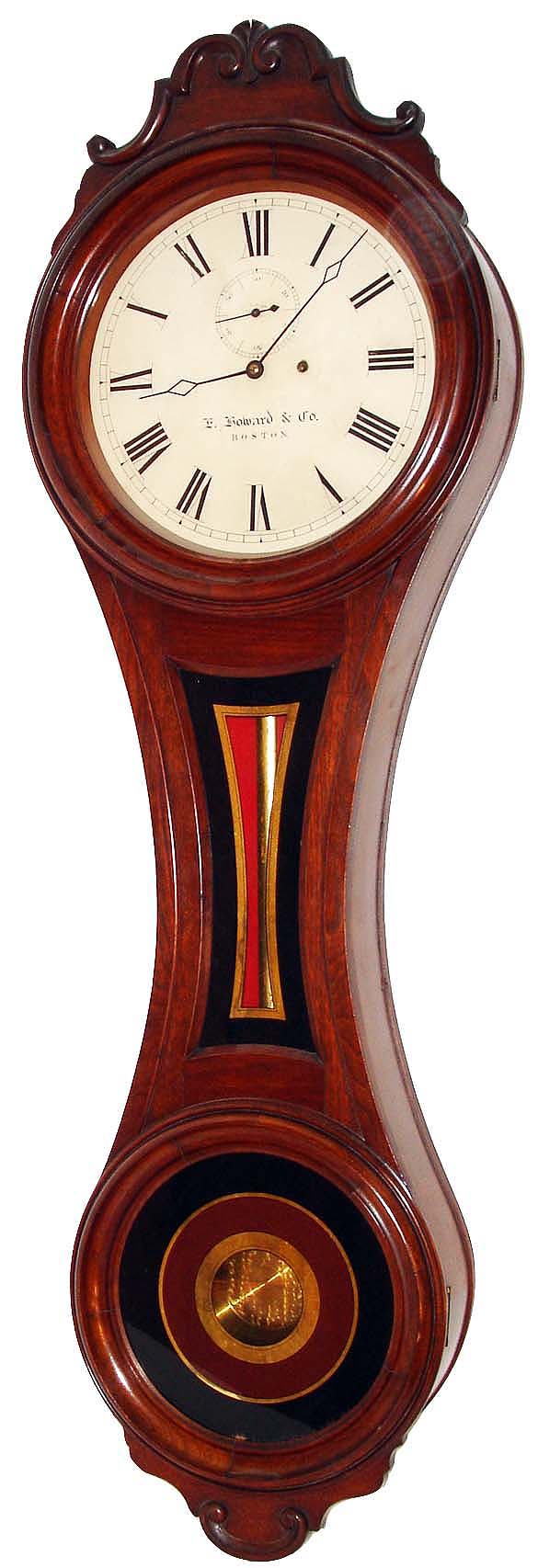 E. Howard & Co., Boston, Mass., "No. 6 Regulator", figure eight wall clock, 8 days, time only, weight driven movement in a black walnut case with a painted iron dial, reverse painted tablets and damascene pendulum bob, c1874 — Antique Clocks Price Guide