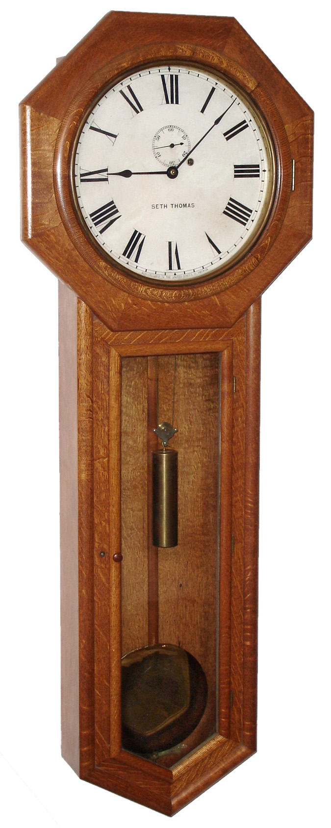 Seth Thomas Clock Co., Thomaston, Conn., "Regulator No. 18", wall clock, 8 days, time only, weight driven movement in an oak case with painted metal dial and 8" diameter pendulum bob, c1890 — Antique Clocks Price Guide