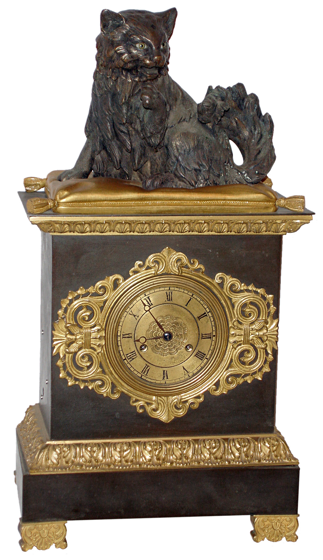 French gilt and patinated bronze 8 days, time and strike, mantel clock, with a bronze figure of a grooming cat sitting on a pillow, the cat with nodding head, c1830, the dark patinated case with gilt trim decorated with acanthus and anthemion, gilt metal dial with engine turned center and black painted Roman numerals, Breguet style hands, and dial trim in the Grecian taste, the pendule a Paris movement with silk thread suspension striking the hours and half hours on a bell, the cat seated on a gilt pillow licks his paw as his head nods powered by a separate movement wound through the left side of the case — Antique Clocks Price Guide