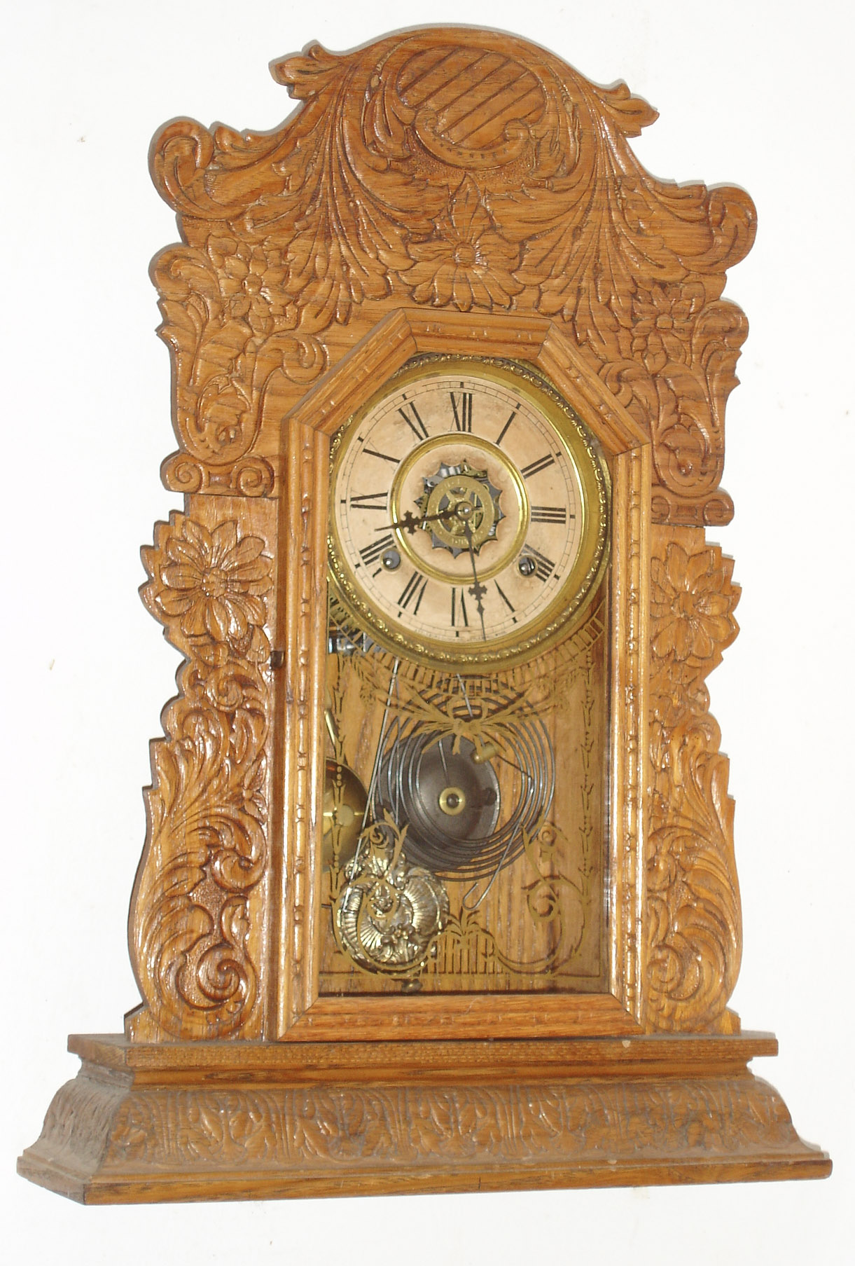 Attleboro Clock Co., Attleboro, Mass., "Improved Royal Assortment -C", 8 day, time and strike, Pressed oak kitchen clock. This was a firm that had clocks made and retailed by them.  Firms such as Ansonia, Waterbury and Ingraham supplied them with clocks, c1900 — Antique Clocks Price Guide