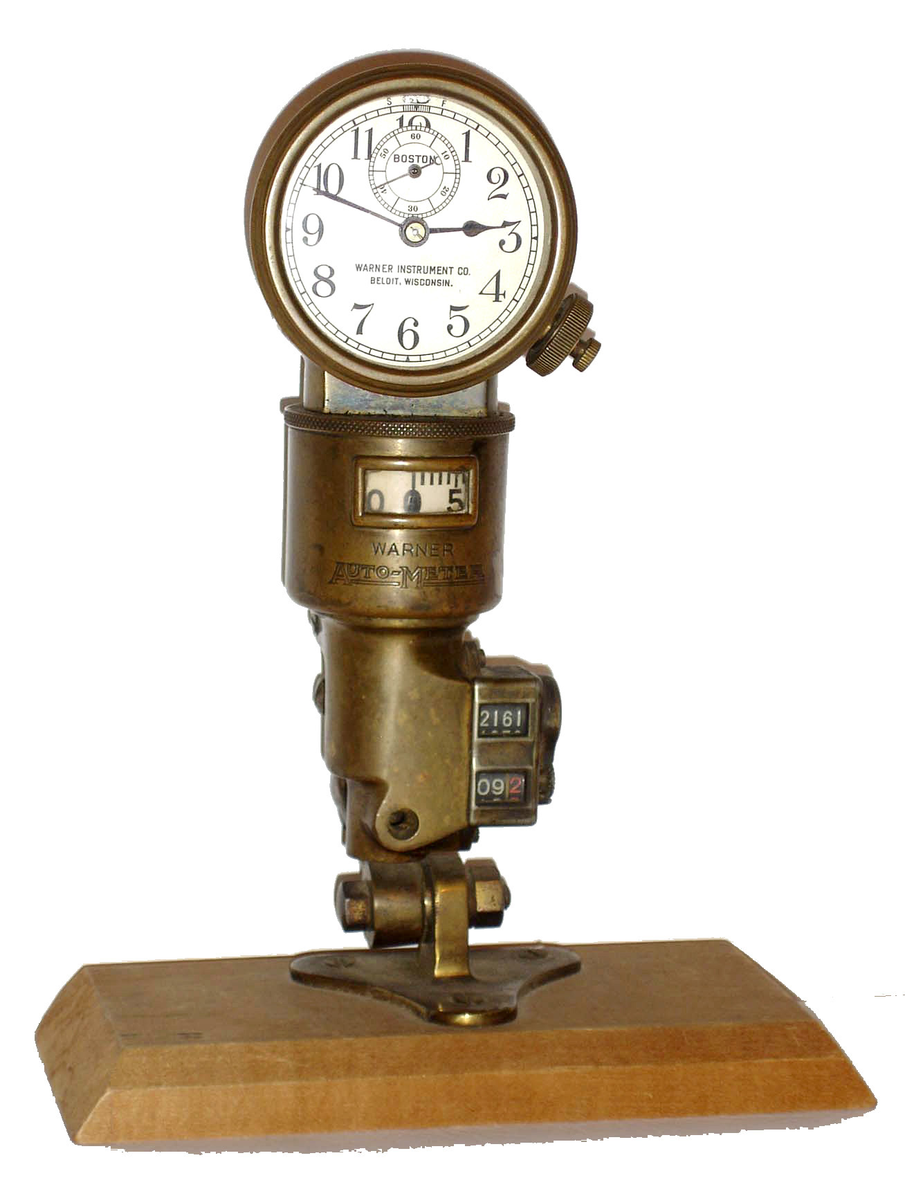 Boston Clock Co., Boston, Mass., for Warner Instrument Co. Beloit, Wisconsin, 8 days, timepiece fitted to the top of a Warner Auto Meter, an early speedometer/ odometer combination. The clock has nickel plates, a lever escapement with balance, silvered dial and blued steel hands. The Auto Meter and clock are contained in a heavy brass case for mounting inside the vehicle. c1900 — Antique Clocks Price Guide