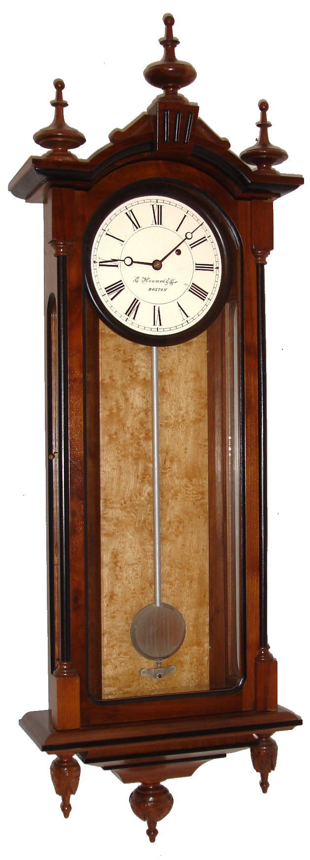 E. Howard & Co., Boston, Mass., "Regulator No. 59-8" reissue, wall clock, 8 days, time only, weight driven movement in a walnut and ebonized case with bird's eye maple weight baffle, three carved lower finials and 8" painted metal dial, dated 1976 — Antique Clocks Price Guide