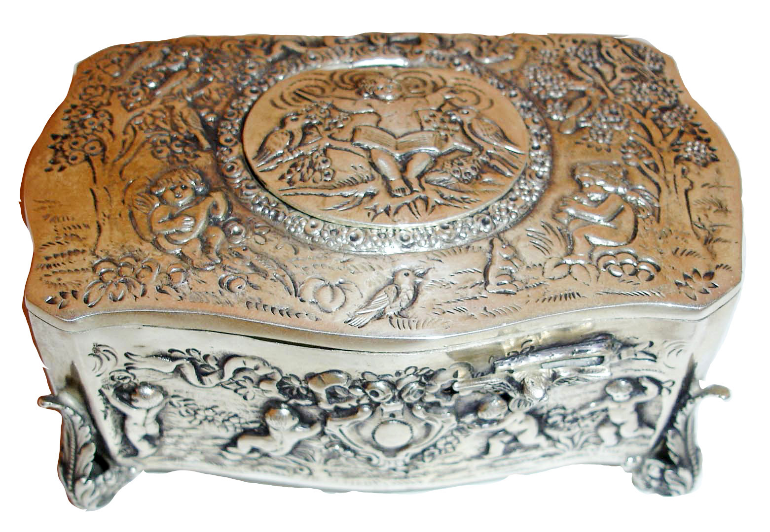 Germany, probably Karl Griesbaum, singing bird box, sterling silver, serpentine form repousse case with landscapes inhabited by putti, on scrolled acanthus form feet, the cover with figure conducting a bird and putti orchestra, the bird with red, green, and black feathers emerges and does his routine when the start slide is pushed, c1950 — Antique Clocks Price Guide