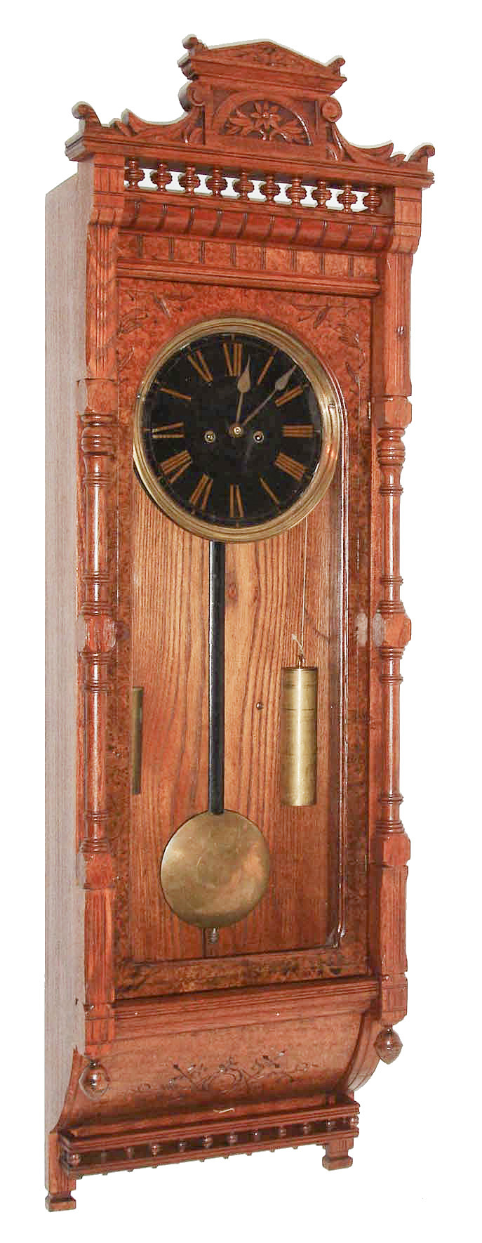 Waterbury Clock Co, "Regulator No 4", "Rosedale", 8 days, weight oak and burl veneer wall timepiece. c1885 This case design was made by both Waterbury and Welch and offered as a two weight timepiece.  This model has an A frame type Waterbury movement. that was not used in the Welch model but a similar looking A frame movement with solid plates was used by Waterbury in some of their regulators. — Antique Clocks Price Guide