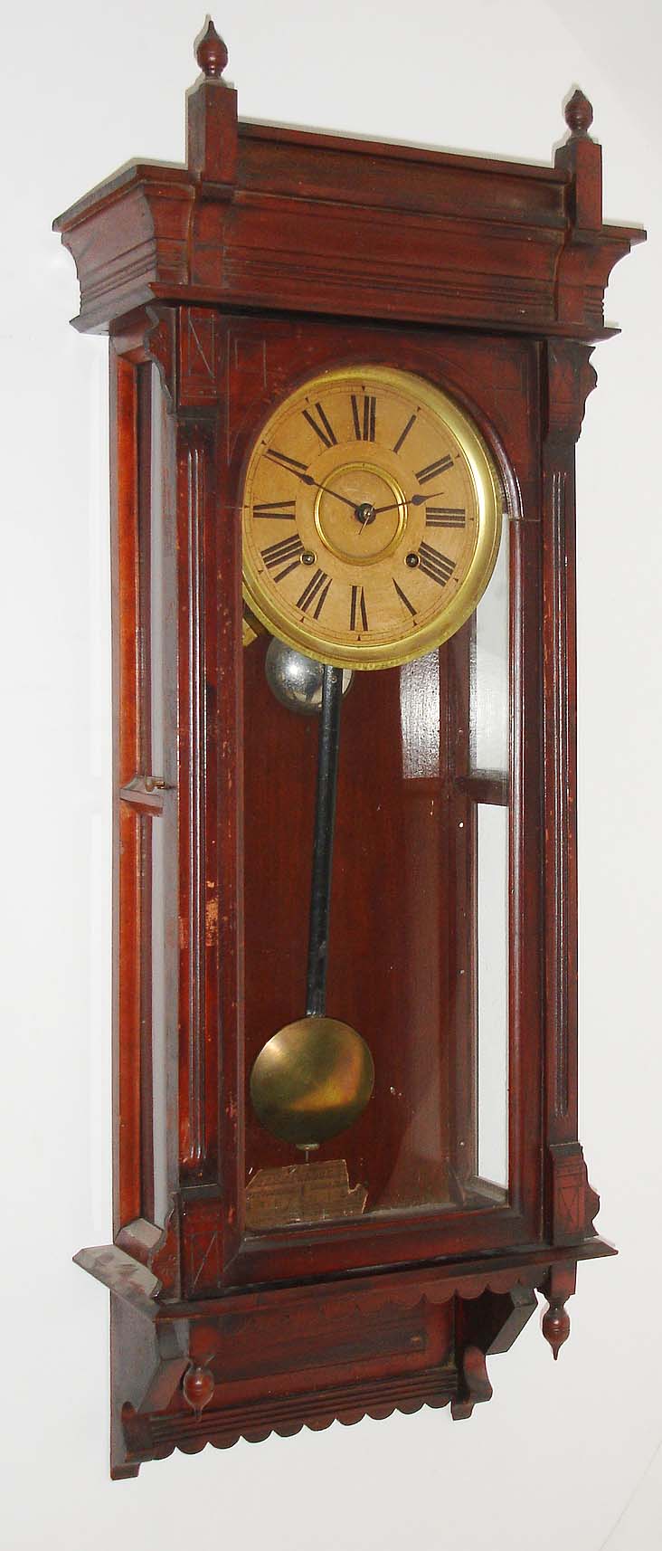 Terry Clock Co., Pittsfield, Mass., "Garland", 8 day, time and strike, spring driven wall regulator, c1885.  This clock was later sold by Russell & Jones who took over the Terry Clock Co. when it failed in 1888.  A picture of this clock can be found in: "Calendar Clocks" by Tran Duy Ly, pg 225. — Antique Clocks Price Guide