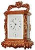 Japy Freres & Cie., France, 8 days, time and strike, hour repeating carriage clock with alarm contained in a gilt, Cariatides style case decorated with trailing vines and C scrolls, four figures in niches at the case corners, an the top with figural handle, beveled glass top and sides, 8 days, brass movement signed "Japy Freres & Cie. Exposition 1855 Grande med. D'honneur", and striking the hours with repeating on demand, silvered platform with English style lever escapement and cut bimetallic balance, Roman numeral, white enamel dial with blued steel trefoil hands, c1870