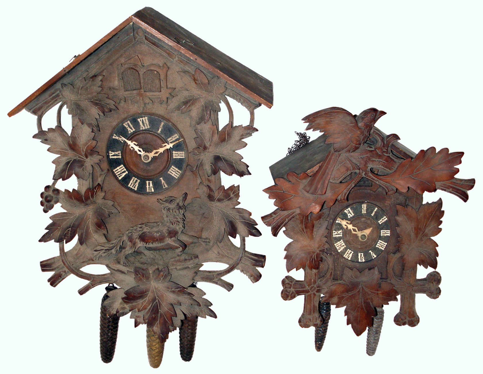 Clocks- 2 (Two) German carved wood cuckoo clocks: 3 weight cuckoo and quail with carved wolf; 2 weight with movement stamped "Faller", early 20th century — Antique Clocks Price Guide