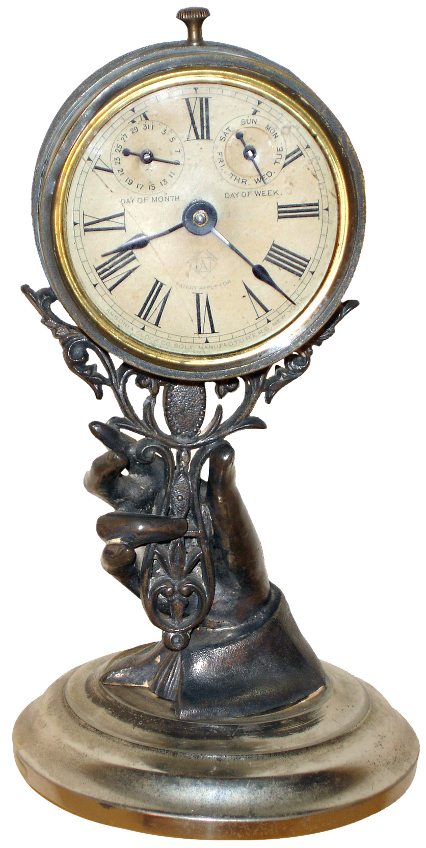 Ansonia Clock Co., New York, N.Y., novelty calendar mantel clock, 30 hours, time and calendar, spring driven movement in an Art Noveau style case depicting lady's hand grasping mirror on nickel plated brass base, papered dial, c1885 — Antique Clocks Price Guide