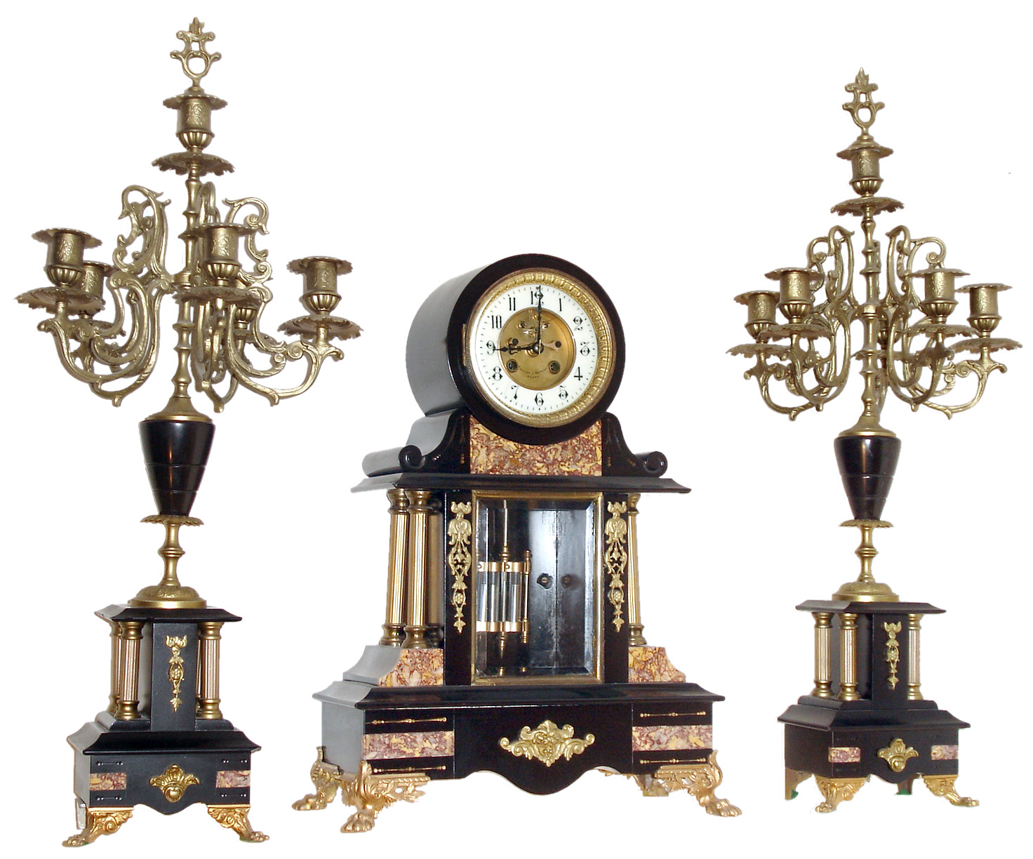 France, 3 piece mantel garniture, black slate drumhead case with columns and inset contrasting marble panels, the case front with beveled glass, applied gilt spelter ornament and animal paw feet, Arabic numeral white enamel dial with sunken center, signed "Philippe & Boisseri Rouen", Brocot open escapement, blued steel hands, 8 days, time and strike, Pendule a Paris movement signed Marti, faux mercury pendulum, with two candelabras of matching materials, design and ornament, c1880 — Antique Clocks Price Guide