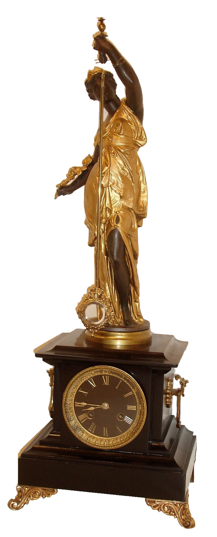 French, "Mystery Clock", the movement with crank & stirrup escape, contained in a black marble case; the painted spelter statue of a robed female holds the suspended pendulum, which swings back and forth with no apparent impulse, black slate dial with incised and gilt Roman numerals, c1885 — Antique Clocks Price Guide