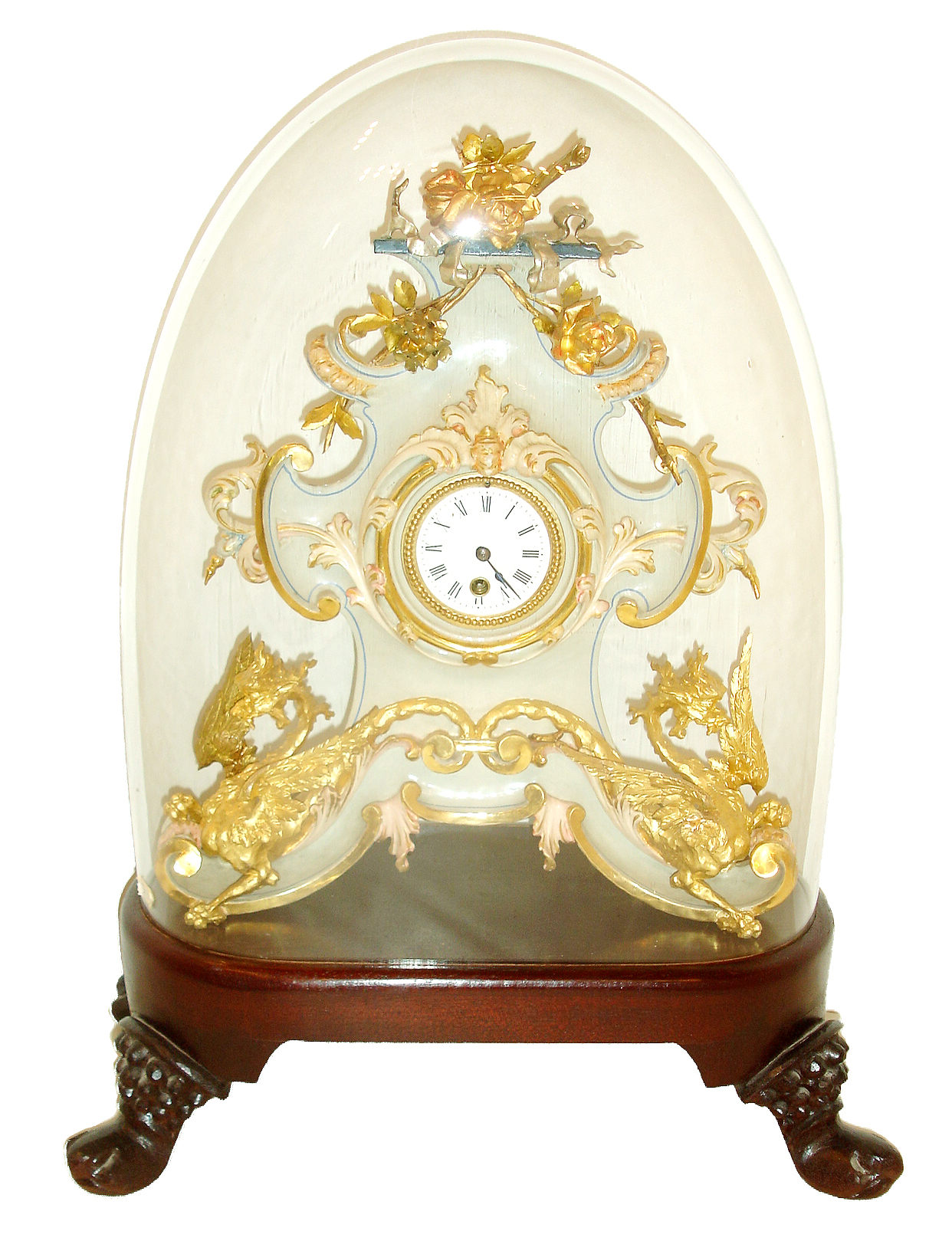 French mantel clock under dome, the case and ornament of carved wood and finished to look like porcelain, with floral and rococo style ornament, and the base with winged dragons, with bright and matte gilding, gilt beaded bezel, Roman numeral white enamel dial, blued steel hands, 8 days, timepiece movement with pendulum, on a modern wood base with period dome, c1860 — Antique Clocks Price Guide