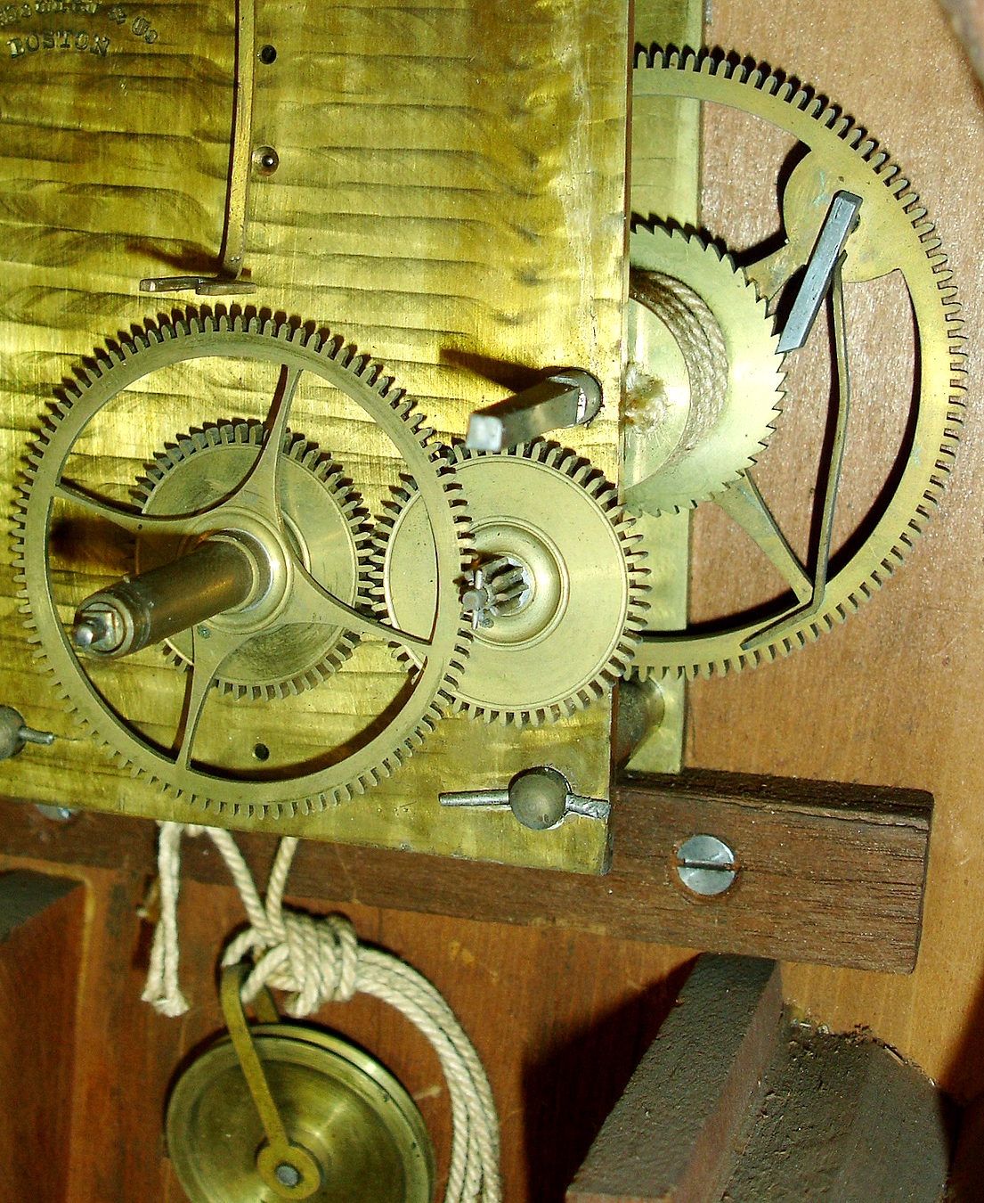 E. Howard & Co., "Regulator No. 4" wall clock, cherry banjo style case with rosewood graining, throat and door glasses with gilt, red, and black decoration, signed Roman numeral white painted metal dial, blued steel moon hands, signed damascened movement, correct cast iron weight, pendulum with wooden rod and damascened ball, red painted weight baffle, case bottom with Howard instruction label, c1875 — Antique Clocks Price Guide