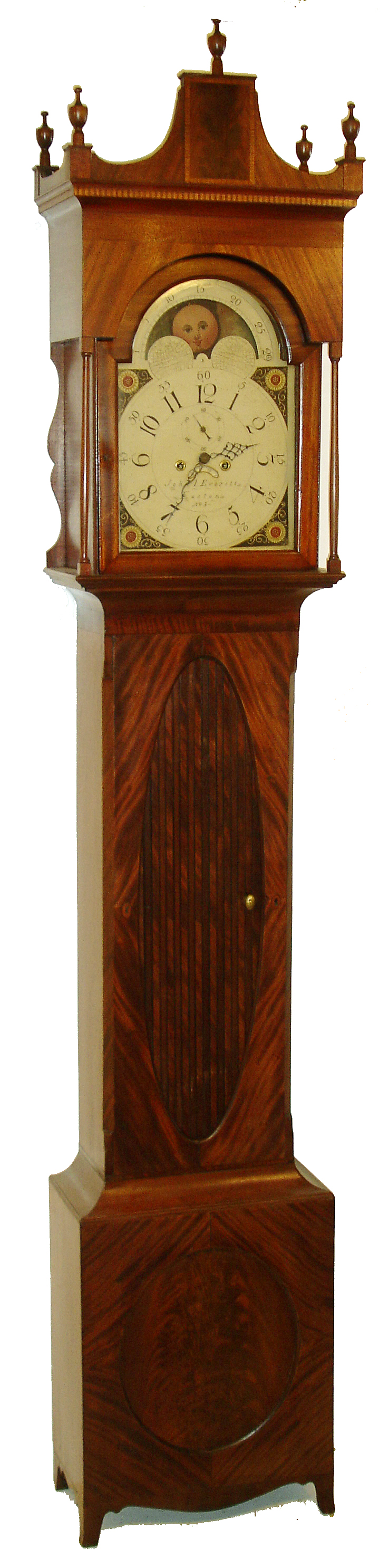 John L. Everitt, Easton, Penn., tall clock, 8 days, time and bell strike, weight driven movement in a mahogany and mahogany veneer case with castle top, unusual tambour door, five finials, and full turned front columns on the hood. The painted iron dial is signed "No. 3" and has moon phase, calendar and sun burst spandrels, c1810 - 1820 — Antique Clocks Price Guide