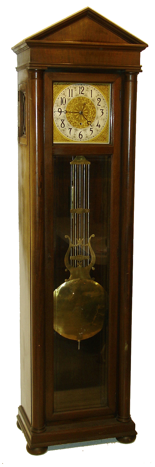 Colonial Manufacturing Co., Zeeland, Mich., "The Judge" tall clock, 8 days, time only, weight driven Swiss style pinwheel escapement movement in an architectural mahogany case with full columns and lower beveled glass and brass dial with sweep seconds hand and silvered chapter ring, c1920 — Antique Clocks Price Guide