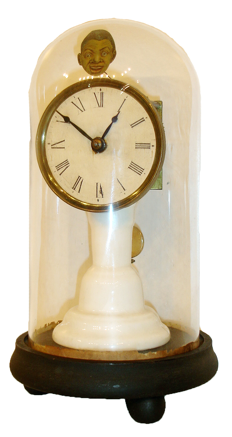 Union Labor Company, Southington, CT, candlestick clock, porcelain column supporting a square plate 30 hours, timepiece with pendulum, pallet arbor with wire and attached caricature of a black man moving from side to side as the clock runs, the lithograph likely cut from a late 19th century trade card, white glossy card stock dial with Roman numerals, spade hands, all on an ebonized base with glass dome, c1865 — Antique Clocks Price Guide