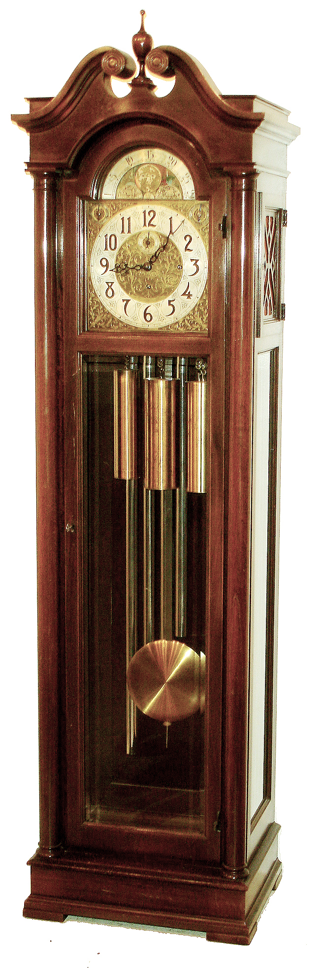 Colonial Manufacturing Co., Zeeland, Mich., tall clock, 8 days, time, strike and Westminster chime, three brass weight driven, large Winterhalder Hofmeier German movement in a mahogany case with beveled glass door and broken arch top. The silvered brass dial has applied numerals, moon phase, strike & chime silent selectors, and brass spandrels, c1910 — Antique Clocks Price Guide