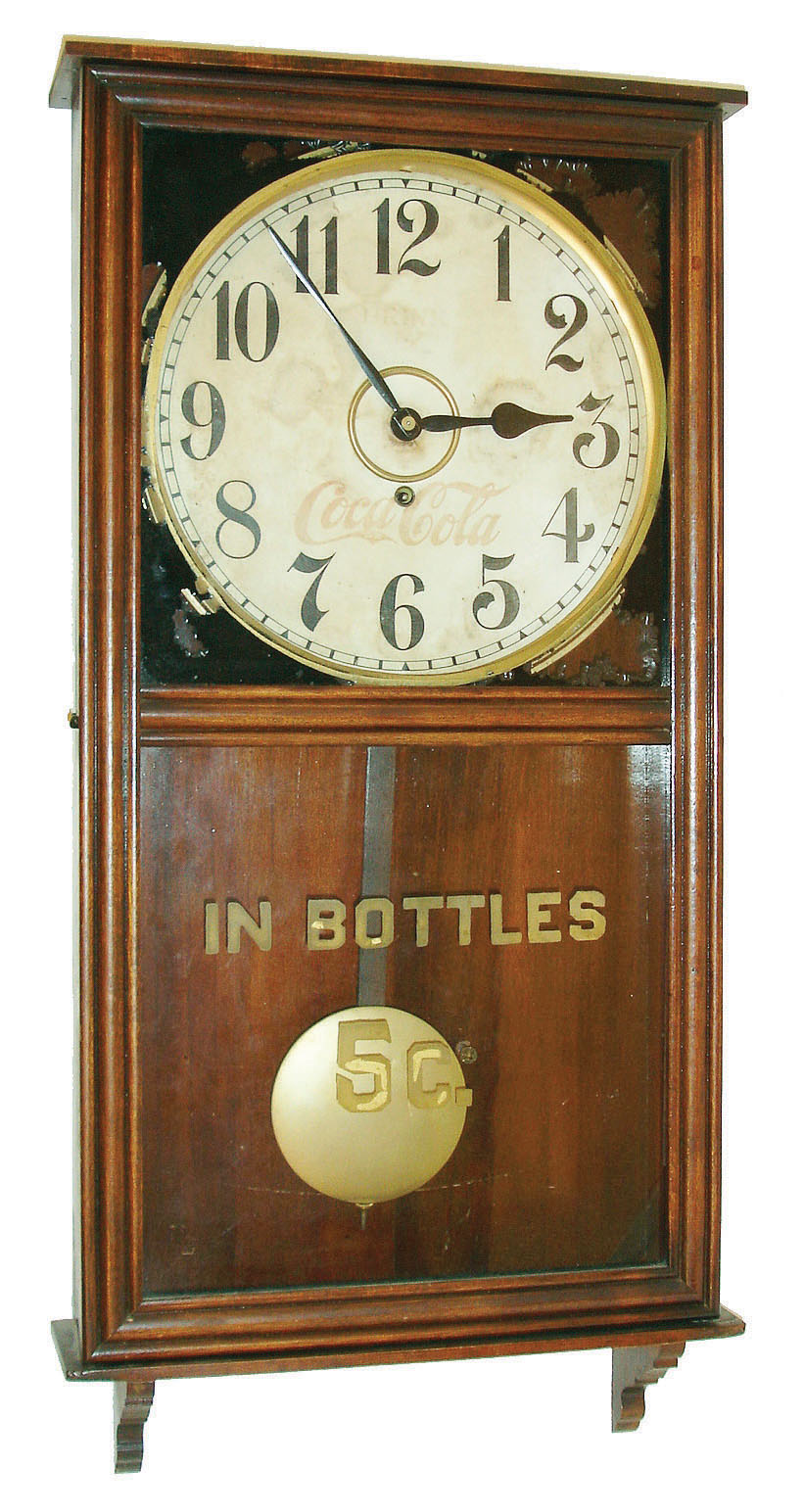 William L. Gilbert Clock Co., Winsted, Conn., "University" hanging store regulator, 8 days, spring driven, time only movement with 12" Coca Cola advertising dial and reverse painted lower glass reading "IN BOTTLES 5c.", c1913 — Antique Clocks Price Guide