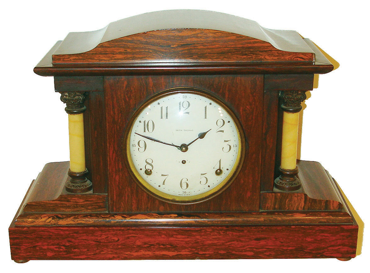 Seth Thomas Clock Co., Thomaston, Conn., wooden case mantle clock. 8 days, time and strike, spring driven movement in a red mahogany adamantine finish with four adamantine onyx columns, c1917 — Antique Clocks Price Guide