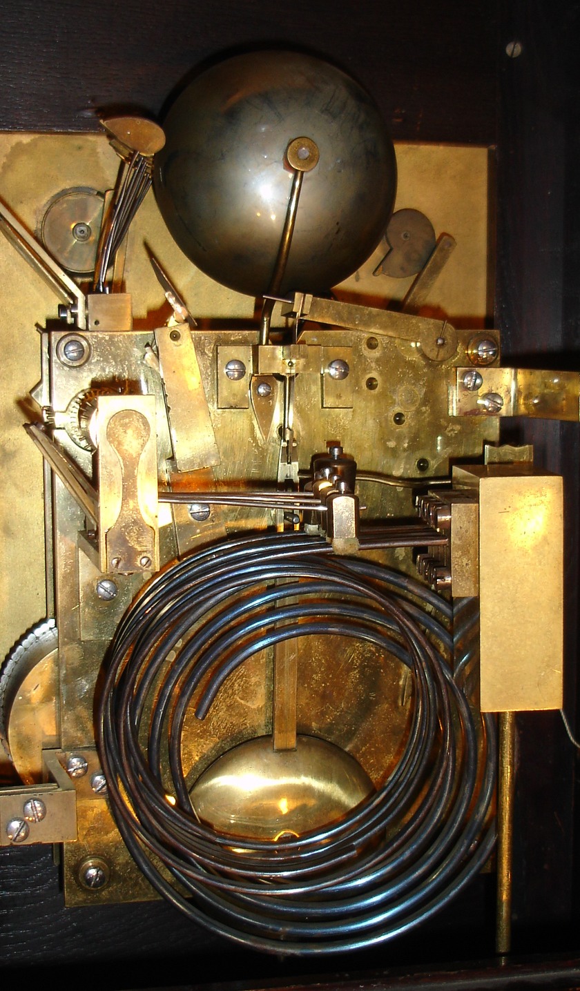 German, oak cased bracket or table clock, 3-fusee, 8-bell, by Winterhalder & Hoffmeier. Chiming the quarters on choice of gongs (Westminster) or bells (Whittington), and with a rectangular dial with gilt cherub spandrels and subsidiary dials for time regulation and choice of tune, c1890 — Antique Clocks Price Guide