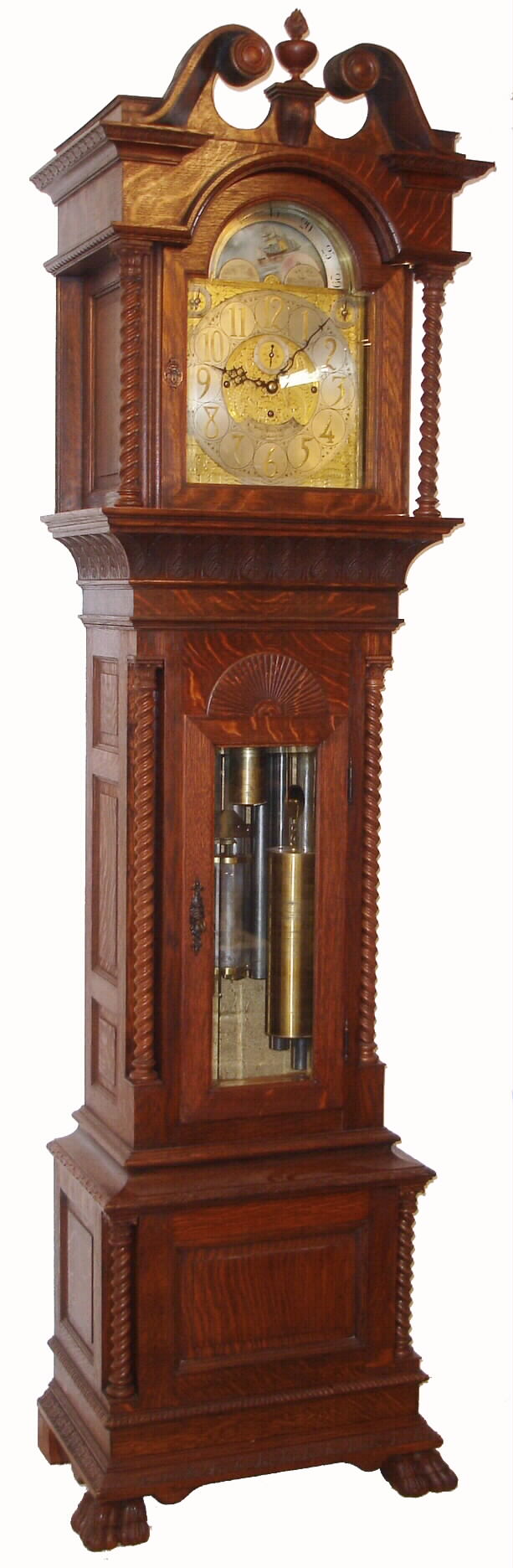 Walter H. Durfee, Providence, Rhode Island, for Bailey, Banks & Biddle, Philadelphia, Penn. on dial, 9 tube hall clock, 8 days, time, strike and 1/4 chime three weight driven movement playing Westminster or Whittington tune on tubes signed by Walter Durfee with patent date 1887 and with single jar mercury pendulum. The silvered brass dial has moon phase with elk scene, strike / silent and tune selector discs. The case is oak with a dark walnut finish and has carved cornice moldings, carved paw feet, broken arch top, 11 raised panels, barley twist columns, of which four are flanking the trunk and two are flanking hood, sunburst carving above trunk door and beveled glass in hood and trunk doors. There are exceptional lion's head escutcheons on both hood and trunk doors, c1895 — Antique Clocks Price Guide