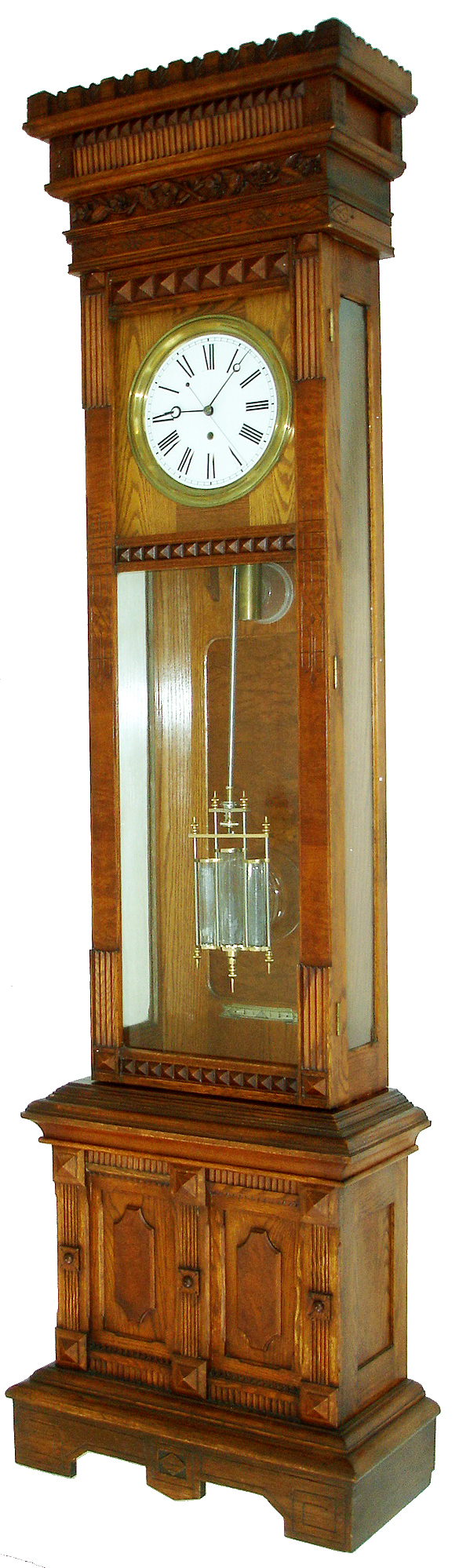 William L. Gilbert Clock Co., Winsted, Conn., "Regulator No. 12 Standing" tall clock, 8 days, time only, weight driven American movement with deadbeat anchor escapement, maintaining power, sweep seconds and a three glass vial mercury pendulum in an oak case with burled frame around door and burled recessed interior panel and white enamel dial, c1895 — Antique Clocks Price Guide