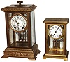 Clocks- 2 (Two) 8 days, time and strike, crystal regulator brass and glass mantel clocks: Seth Thomas "Empire"; Ansonia "Dolphin"; early 20th century