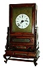 Chinese bracket clock, the 3 part case of carved camphor wood, base cabriole legs and rotating table, front of base and lower case set with mirrored panels, lower case also with quatrefoil cutouts at sides and backed with soapstone or alabaster, upper case with glazes sides to enable viewing of movement, Roman numeral white enamel dial, blued steel hands, cast and engraved dial surround, 8 days, time and strike, fusee movement with verge escapement, Chinese characters engraved on back plate, movement mounting brackets also with engraving, 19th century