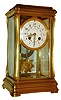French crystal regulator for Bigelow, Kennard & Co., Boston, gilt brass case with subtle Art Nouveau styling, the top and base with gently incurved sides, and with moldings similar to a Gorge style carriage clock, beveled glass panels, Arabic numeral white enamel dial with polychrome floral swags, gilt Louis XV style hands, gilt sunburst pendulum with mask, 8 days, time and strike, Pendule a Paris movement with Brocot escapement, and marked Japy Freres, c1900
