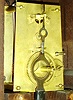 Baltimore banjo wall clock, attributed to George Hatch, North Attleboro, Mass., case with rosewood graining, asphaltum backed glasses with gold leaf decoration, Roman numeral white painted metal dial, correct and probably original blued steel Tulip style hands, brass 8 days, timepiece movement, original iron weight with tapered wooden plug for securing weight in transport, gilt wooden pendulum rod, brass pendulum ball, c1855