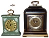 Clocks- 2 (Two) English time only 8 days, desk clocks: Elliott black and gold painted wood small bracket clock with Tiffany brass and silvered dial, dated 1960; Baronet of London green Wedgewood small bracket clock dated 1971