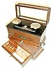 Christian Becker "Chainomatic" analytical balance scale; Torsion Balance Co., New York balance scale and drawer box of weights; two meters by "The Standard Electric Clock Co."; Hygrometer by "Philathermo Co."