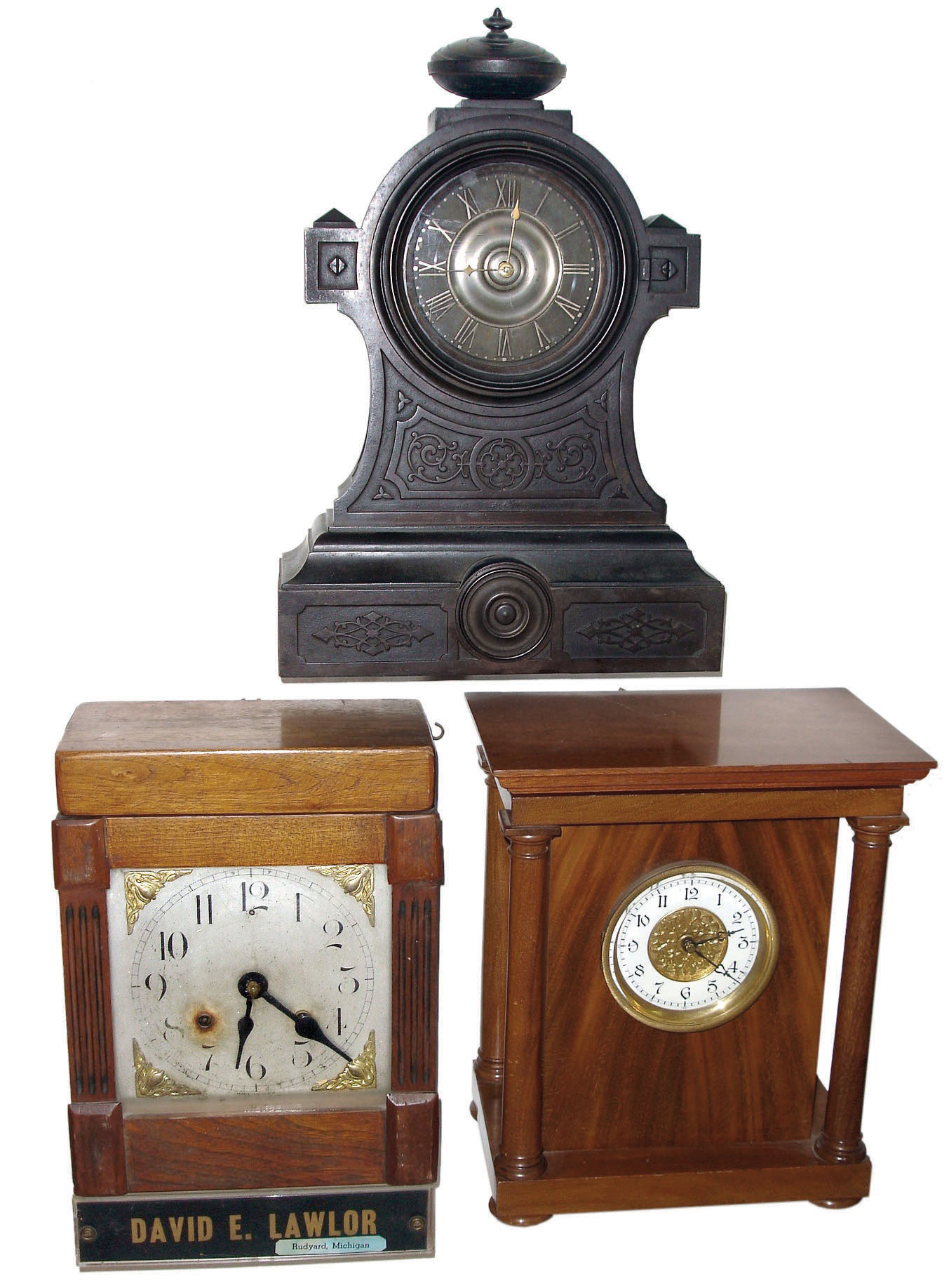 Clocks- 3 (Three) American mantel clocks: American Clock Co., Chicago, Ill. self-winding movement in walnut case, c1905; American Clock Co., New York "Tucker Bronze" iron case 8 days, time and strike, c1875; Ansonia Clock Co., 8 days, time and strike, movement in a 20th century purpose-made oak case with "David E. Lawler" on its base. — Antique Clocks Price Guide