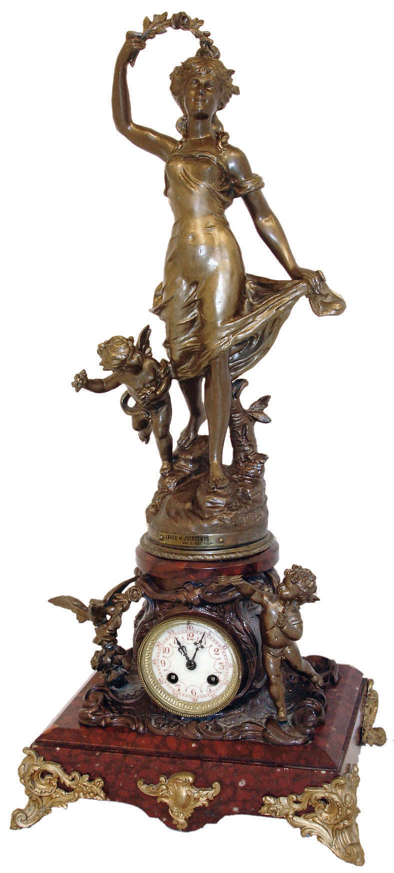 France, large figural mantel clock, griotte marble base with gilt French scroll feet supporting a patinated spelter clock case resting on a bed of c scrolls and foliage, and flanked by a figure of cupid, opposite a garland of roses carried by a bird, the case top with patinated spelter group, titled "Amour et Printemps" (Love and Spring), after the sculpture by Guillemin, the female figure in flowing dress, and with cupid at her feet, Arabic numeral white enamel dial, blued steel hands, 8 days, time and strike, pendule a Paris movement, marked Japy Freres, c1900 — Antique Clocks Price Guide