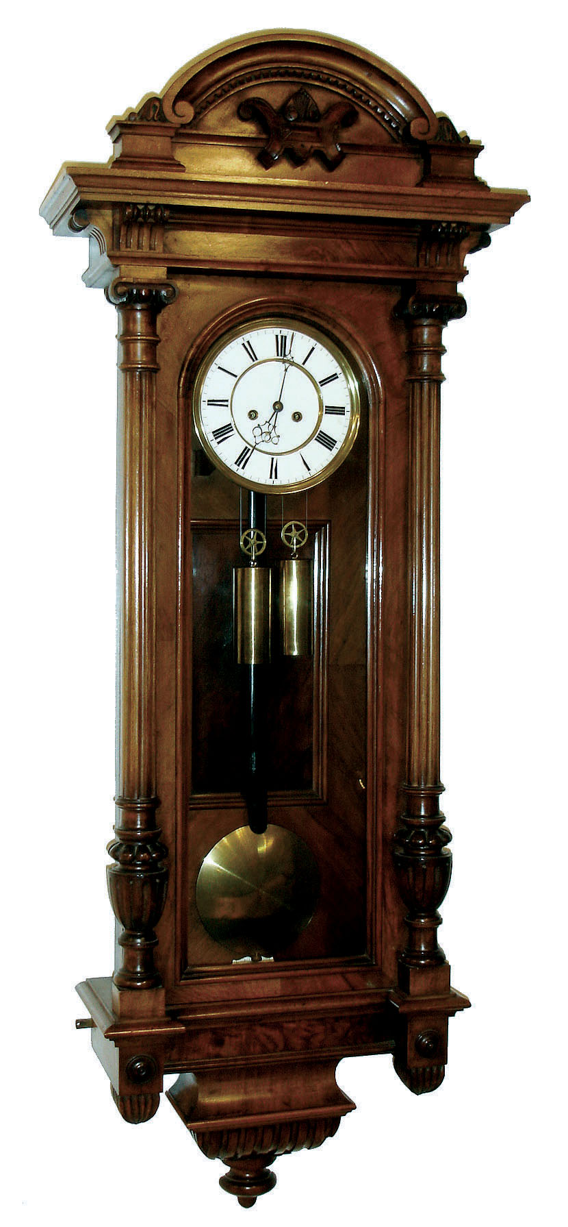Vienna regulator, walnut and walnut veneer case with carved ornament, removable crest also with carving, door with turned and carved columns, Roman numeral white enamel dial with pierced blued steel hands, brass 8 days, time and strike, movement, 5 spoke pulleys, brass pendulum with ebonized wooden rod, brass weights, c1890 — Antique Clocks Price Guide