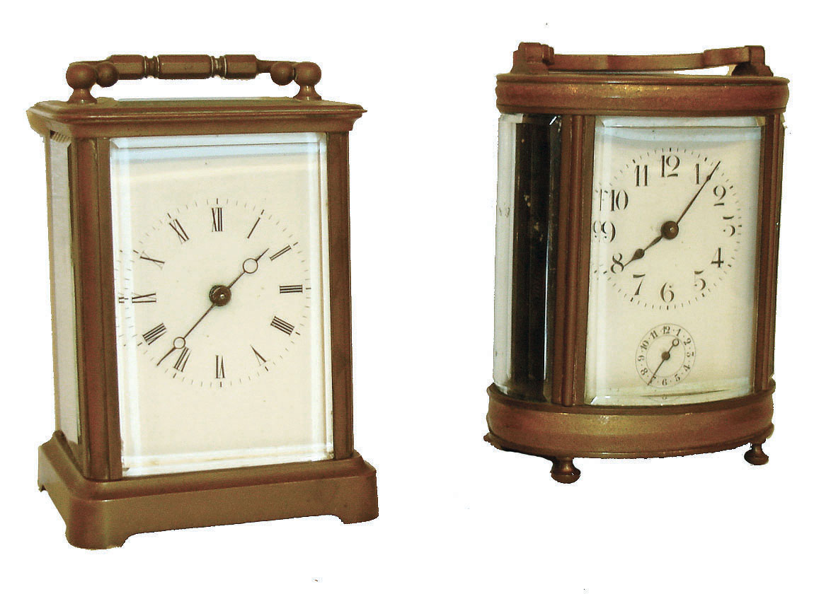 Clocks- 2 (Two): French carriage clocks, the first with typical brass case and beveled glass panels, Roman numeral white enamel dial, Breguet style hands, 8 day timepiece movement with cylinder platform, the other with oval brass case and turned brass feet, beveled glass panels, Arabic numeral white enamel dial, 8 day time and alarm movement with lever platform, both early 20th century — Antique Clocks Price Guide
