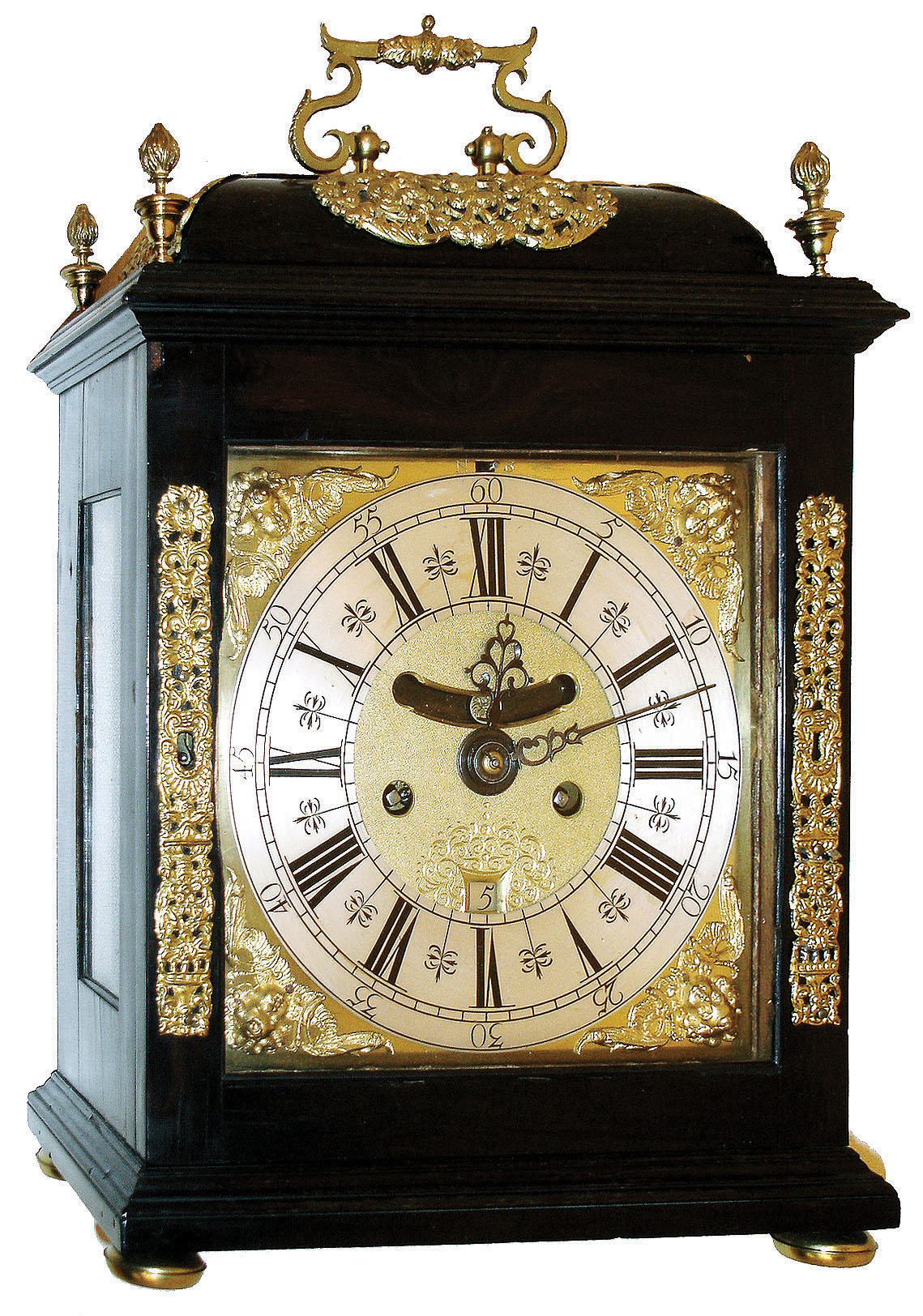 Early English bracket clock, ebony veneered oak case with domed top, glazed sides and back, and with decorative cast mounts, all resting on turned brass feet, Roman numeral composite dial with winged cherub spandrels, silvered chapter ring, matted and engraved center, aperture above center arbor displaying mock pendulum, and with date display below, blued steel hands, 8 days, time and strike, 6 pillar fusee movement with verge escapement and engraved back plate, back cock mounted with large ornamental cast plate, originally fitted with Dutch striking, now removed, as currently configured striking the hours on a bell, the rack fitted between the plates and gathered by a pallet fitted to the third wheel arbor, c1700 — Antique Clocks Price Guide