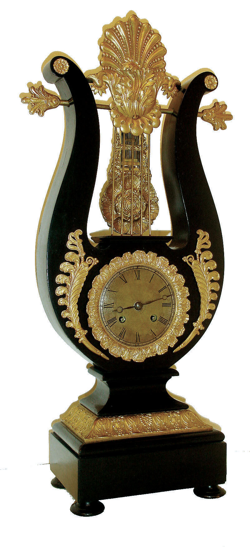 France, lyre clock, ebonized wooden case with gilt ornament, Roman numeral silvered dial with engine turning, blued steel Breguet style hands, gridiron style pendulum with scallop shell ornament suspended above the movement and behind the lyre strings, case back with purpose made cover for the exclusion of dust, 8 days, time and strike, pendule a Paris movement, c1840 — Antique Clocks Price Guide
