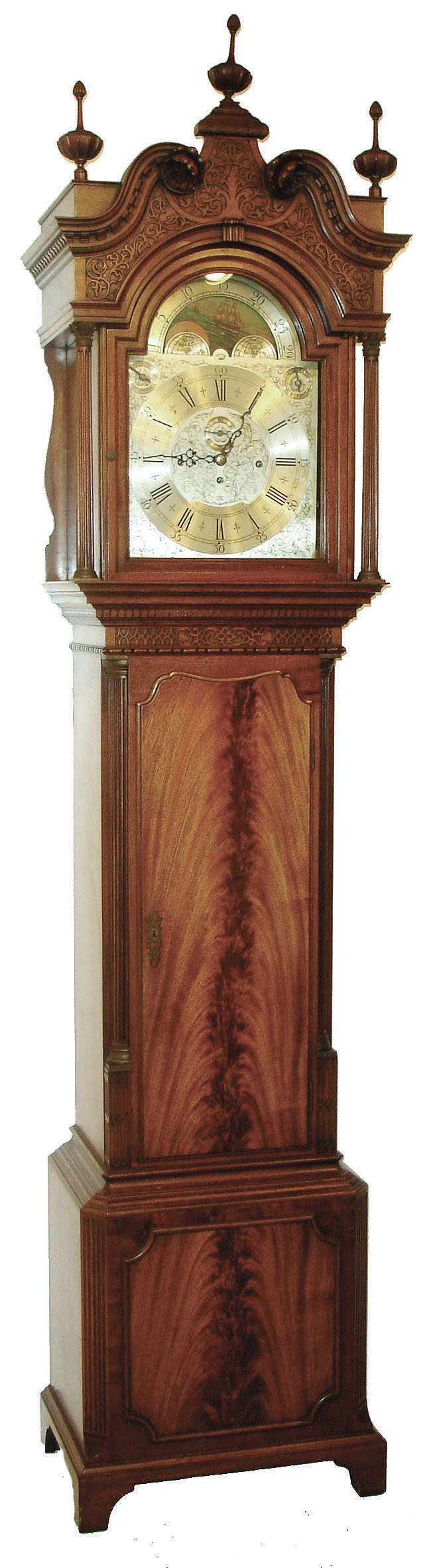 Herschede Clock Co., Cincinnati, Ohio, custom 9 tube hall clock, 8 day time, strike & chime, three weight driven movement playing three tunes, Westminster, Wittington, Canterbury in a mahogany case with fluted Corinthian quarter columns on trunk and base, bracket feet, crotch mahogany panels on door and base, carved relief work on arch above dial and above door and full fluted columns with brass Corinthian tops and bases. The broken arch top has carved floral rosettes, dental molding and fine cup finials. The silvered engraved dial has wax filled Roman numerals on an applied chapter ring and moon phase, c1921 — Antique Clocks Price Guide