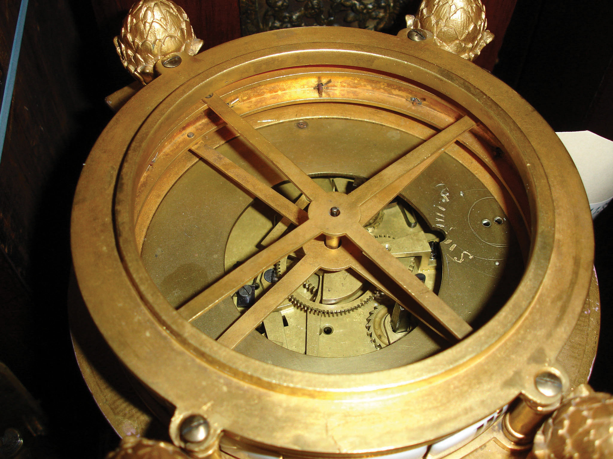 France, table clock with annular time display, architectural porcelain case mounted to a gilt brass foliate molded base, the cylindrical case with Corinthian columns, pink glaze with gilt highlights, and 4 painted panels of very good quality and with gilt frames, the front featuring Chronos bearing a portrait of Louis XVI, surrounded by three putti, one with hourglass, one with scythe, the last with laurel fronds, the sides with full length portraits of women in classical dress, and the back with a basket of flowers suspended by a bowknot, with a background of roses, forget me nots, coneflowers, and two colorful birds, the time display on two rings with Roman and Arabic numeral white enamel cartouches, beneath the domed top with bowknot and floral decorated band, and gilt brass putti playing a lute, c1880 — Antique Clocks Price Guide