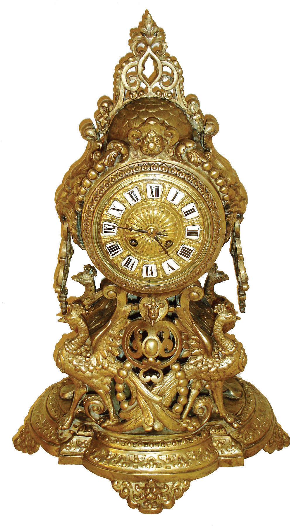 France, ornate cast brass mantel clock, the case with pierced Arabesque ornament, domed top, sides with large lion masks and drop handles, a pair of hybrid pea fowl - griffins beneath the clock, all on a round end base with mask decorated feet, cast bezel with convex beveled glass, cast dial with applied Roman numeral cartouches, blued steel hands, 8 days, time and strike, pendule a Paris movement, c1880 — Antique Clocks Price Guide