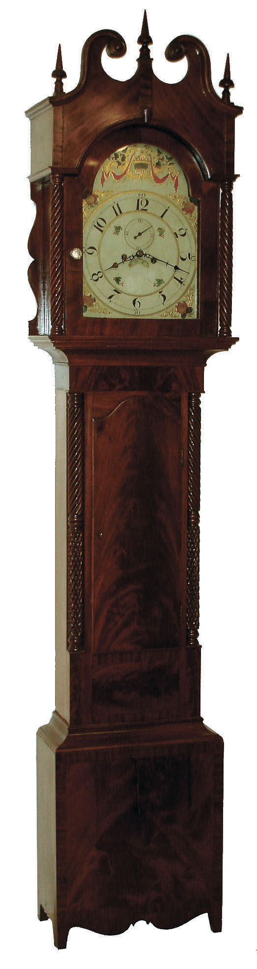 Tall clock attributed to Isaac Brokaw, Bridgetown & Elizabethtown, New Jersey. 8 days, time and strike, on bell, weight driven brass movement in a mahogany veneer case with high arch top, barley twist full columns flanking hood and barley twist and cross hatched 3/4 columns flanking trunk on a base with finely shaped skirt and straight feet. The American made painted metal dial has calendar date aperture, Arabic numerals and subsidiary and fruit motif, c1825 — Antique Clocks Price Guide