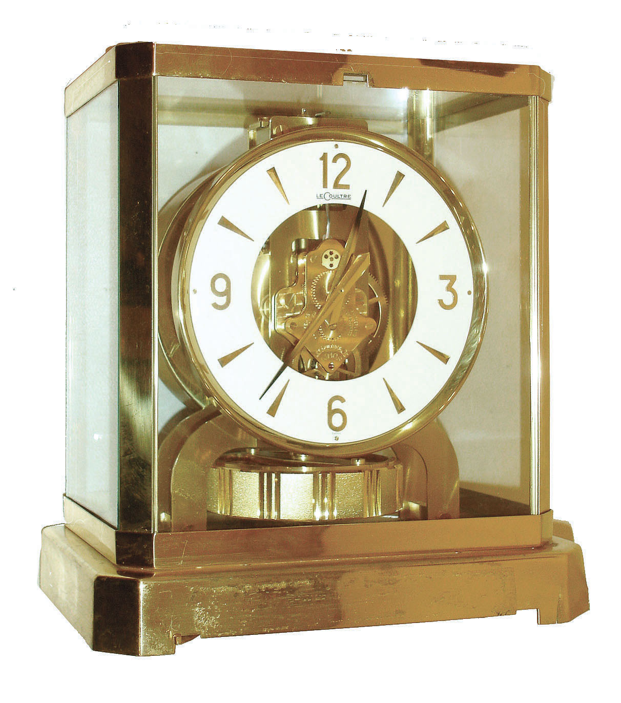Jaeger - LeCoultre, Switzerland, "Atmos" clock, 15 jewel gilt caliber 528 movement, gilt torsion pendulum, round white painted dial with applied gilt Arabic numerals and arrow markers, gilt hands with black painted tips, all contained in a glazed rectangular case with removable front panel, serial #318165 — Antique Clocks Price Guide