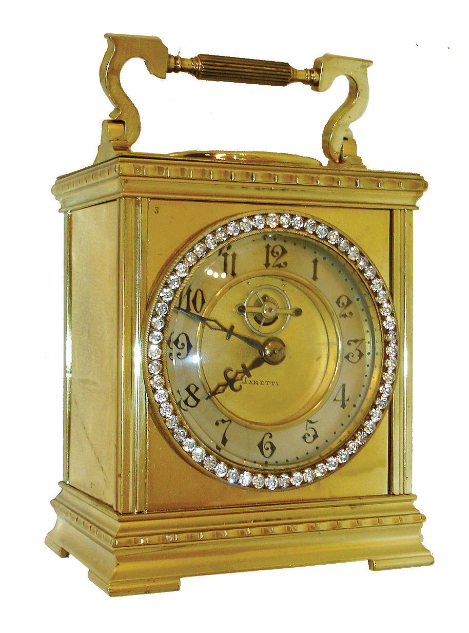 France, 8 days, time only, carriage clock with heavy, polished brass case with carrying handle, the top set with a thermometer & compass, the front with brilliant set bezel, Arabic numeral silvered dial with gilt, sunken center signed "Janetti", the exposed 3-spoke balance oscillating below 12:00, blued steel hands, c1910 — Antique Clocks Price Guide