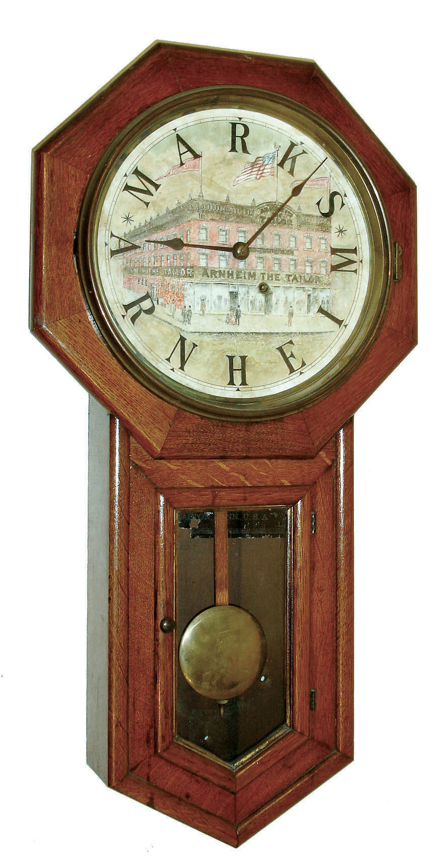 Seth Thomas Clock Co., Thomaston, Conn., "Globe" model 8 days, time only, drop octagon advertising wall clock in an oak case with personalized painted and hand colored advertising dial with a view of the establishment of "Arnheim the Tailor in the Manhattan's Bowery district 190, 192, & 194 Bowery at the corner of Spring St." [New York] with "MARKS ARNHEIM" substituted for numerals 1 - 12, c1890 — Antique Clocks Price Guide